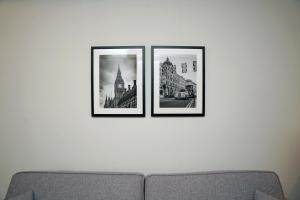 three framed photographs on a wall above a couch at The Londoner Hotel Sliema in Sliema