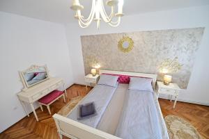 een slaapkamer met een bed met 2 tafels en een piano bij FLH - Natalia 1 - Turnisor in Sibiu