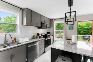 a kitchen with gray cabinets and a counter top at 10 Min to Downtown-Modern in Magic City-Both Units in Birmingham