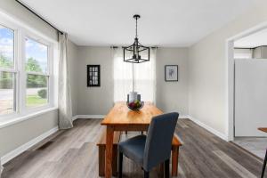 a dining room with a table and a chair at 10 Min to Downtown-Modern in Magic City-Both Units in Birmingham