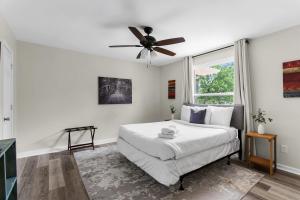 a bedroom with a bed and a ceiling fan at 10 Min to Downtown-Modern in Magic City-Both Units in Birmingham