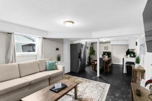 a living room with a couch and a kitchen at 10 Min to Downtown-Modern in Magic City-Both Units in Birmingham