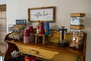 a table with food and a sign on a wall at Pet Friendly Treehouse Vibe with Hot Tub & Fire Pit in Fredericksburg +49 photos