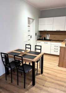 a kitchen and dining room with a table and chairs at Rajcuś in Rajcza