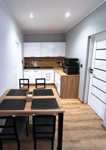 a kitchen with a table and chairs in a room at Rajcuś in Rajcza +13 photos