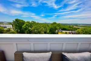 a balcony with two chairs and a view of trees at Stay GOODrich in Nashville