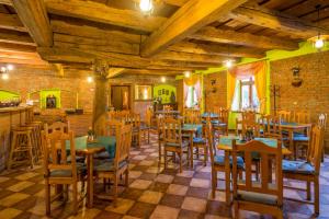 a restaurant with wooden tables and chairs in a room at Hotel Penzion Trámky in Vikýřovice