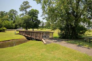 a bridge over a pond in a park at River Oaks 40D in Myrtle Beach