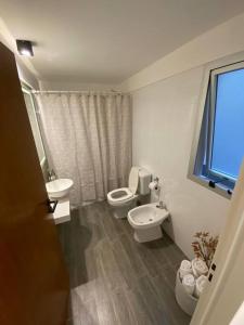 baño con 2 aseos, lavamanos y ventana en Elegante 2 ambientes en Belgrano Cramer y Olazabal en Buenos Aires