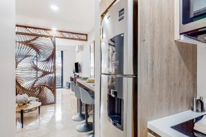 a kitchen with a stainless steel refrigerator and a counter at Perfect Place 302 in Playa del Carmen