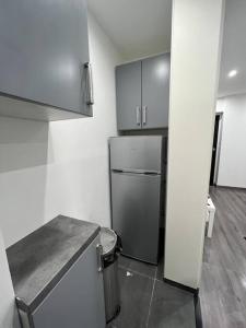 a small kitchen with a refrigerator in a room at Beau T2 à Arcueil proche RER B. in Arcueil