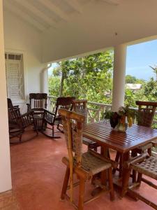- une terrasse couverte avec une table et des chaises en bois dans l'établissement Casa yaan, à Las Galeras