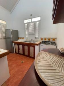 a kitchen with a sink and a stove at Casa yaan in Las Galeras