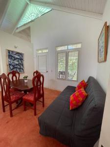 a living room with a black couch and a table at Casa yaan in Las Galeras