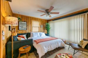 a bedroom with a bed and a ceiling fan at Lakefront, wildlife Cabin retreat - Sauna optional in Lindstrom