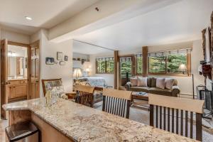 a kitchen and living room with a table and chairs at Laurelwood Condominiums 205 in Snowmass Village