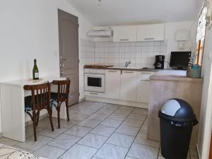 a kitchen with a counter and a table and chairs at Chalet 25 m de la mer in Ault