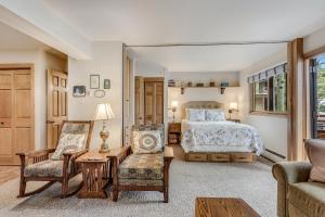 a bedroom with a bed and a couch and a chair at Laurelwood Condominiums 205 in Snowmass Village