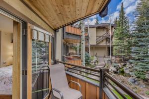 a balcony with a chair and a view of a house at Laurelwood Condominiums 205 in Snowmass Village