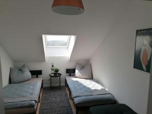 a room with two beds and a window at Meisterhaus Apartment 8 in Glauchau