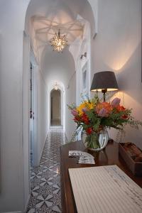 a room with a table and a vase filled with flowers at Affittacamere Capri Dolce Vita in Capri