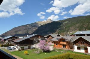 a group of houses in front of a mountain at Hotel Les Bruyères in Morzine
