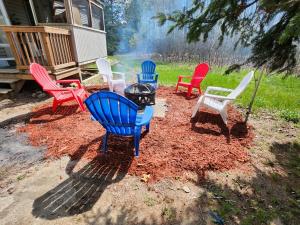 a group of colorful chairs sitting in a yard at Mi-o My Getaway in Mio