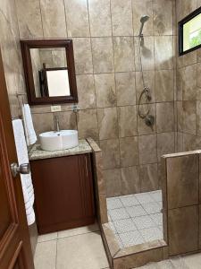 a bathroom with a sink and a shower at Real Paraiso in Juticalpa