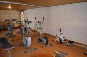 a gym with several exercise equipment in a room at Hotel Les Bruyères in Morzine