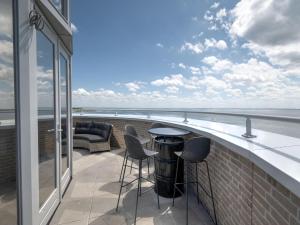 a balcony with chairs and a table on a building at Premium apartment in Scherpenisse with roofed terrace in Scherpenisse