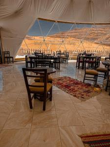 a group of tables and chairs in a tent at Wadi Rum Relaxation Camp in Wadi Rum