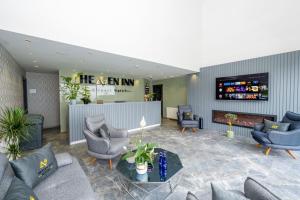 a lobby with couches and chairs and a bar at Heaven Inn Airport Hotel in Arnavutköy