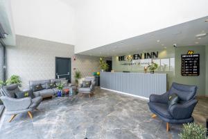 a lobby with couches and chairs in a building at Heaven Inn Airport Hotel in Arnavutköy