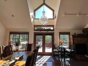 a large room with a dining table and a chandelier at Wood's Lodge in Whitefish