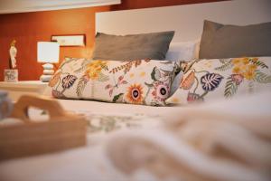 a bed with two pillows with flowers on it at Penthouse Duplex in a 5 floors typical spanish house-8 min to Center by Metro in Valencia