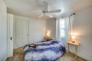 a bedroom with a blue bed and a ceiling fan at Peaceful Pittsburgh Townhome with Large Yard in Pittsburgh