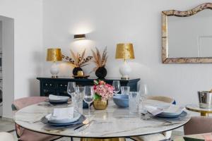 een eettafel met borden en glazen erop bij luxurious frontline penthouse in puerto banus in Marbella