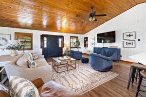 Una sala de estar con un sofá y un ventilador de techo. en Wolf Bay House, en Elberta
