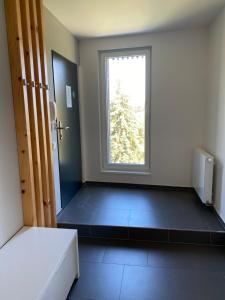 um quarto vazio com uma janela e uma cama em Apartmán v LakeParku em Staré Splavy