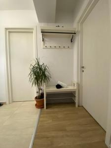 a room with a couch and a plant in it at New building with private parking, big balcony and a stunning view in Bragadiru