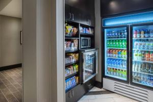 a refrigerator filled with lots of soda and drinks at Fairfield Inn & Suites by Marriott Boston Logan Airport/Chelsea in Chelsea