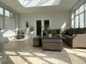 a living room with a couch and a table at Stunning and luxurious Manor House holiday home in Broadmayne