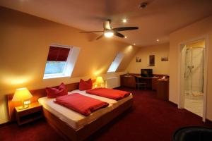 a bedroom with a bed and a ceiling fan at Landhaus Eden 3 Sterne Superior in Soltau +63 photos