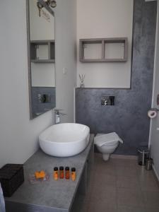 a bathroom with a large white tub and a toilet at YAMADA in Năvodari +25 photos