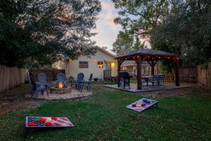 a backyard with a fire pit and a gazebo at The Green Bench Cottage - Pet Friendly in St. Petersburg