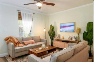 a living room with a couch and a table at The Green Bench Cottage - Pet Friendly in St Petersburg