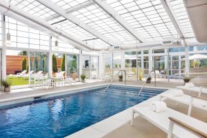 a pool in a building with a large glass ceiling at Element Lexington in Lexington