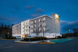 a large white building in front of a parking lot at Element Lexington in Lexington