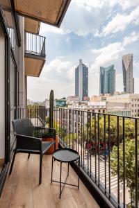 a balcony with a view of a city skyline at Londres 256 by Wynwood House in Mexico City