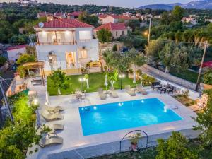 an aerial view of a house with a swimming pool at Villa Erasmia- House 2 upper floor in Sarláta